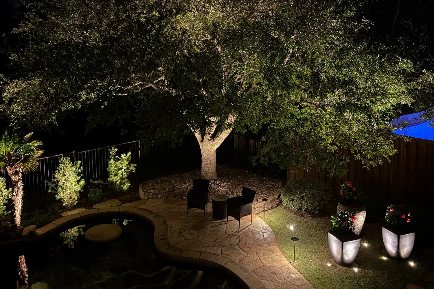 Christmas light installation on a North Texas ranch home at dusk
