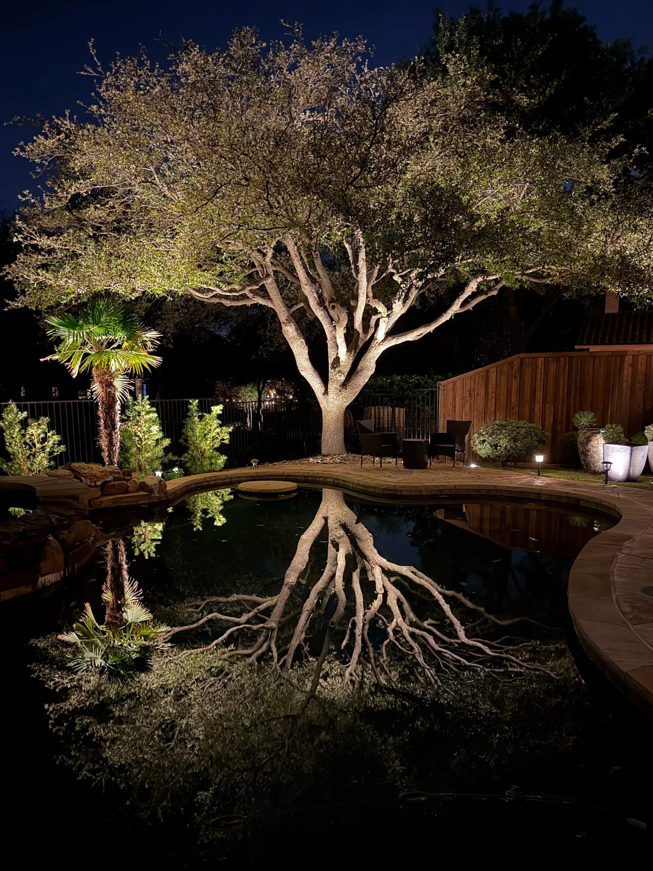 Nighttime landscape lighting on a North Texas home by K Legacy Lighting