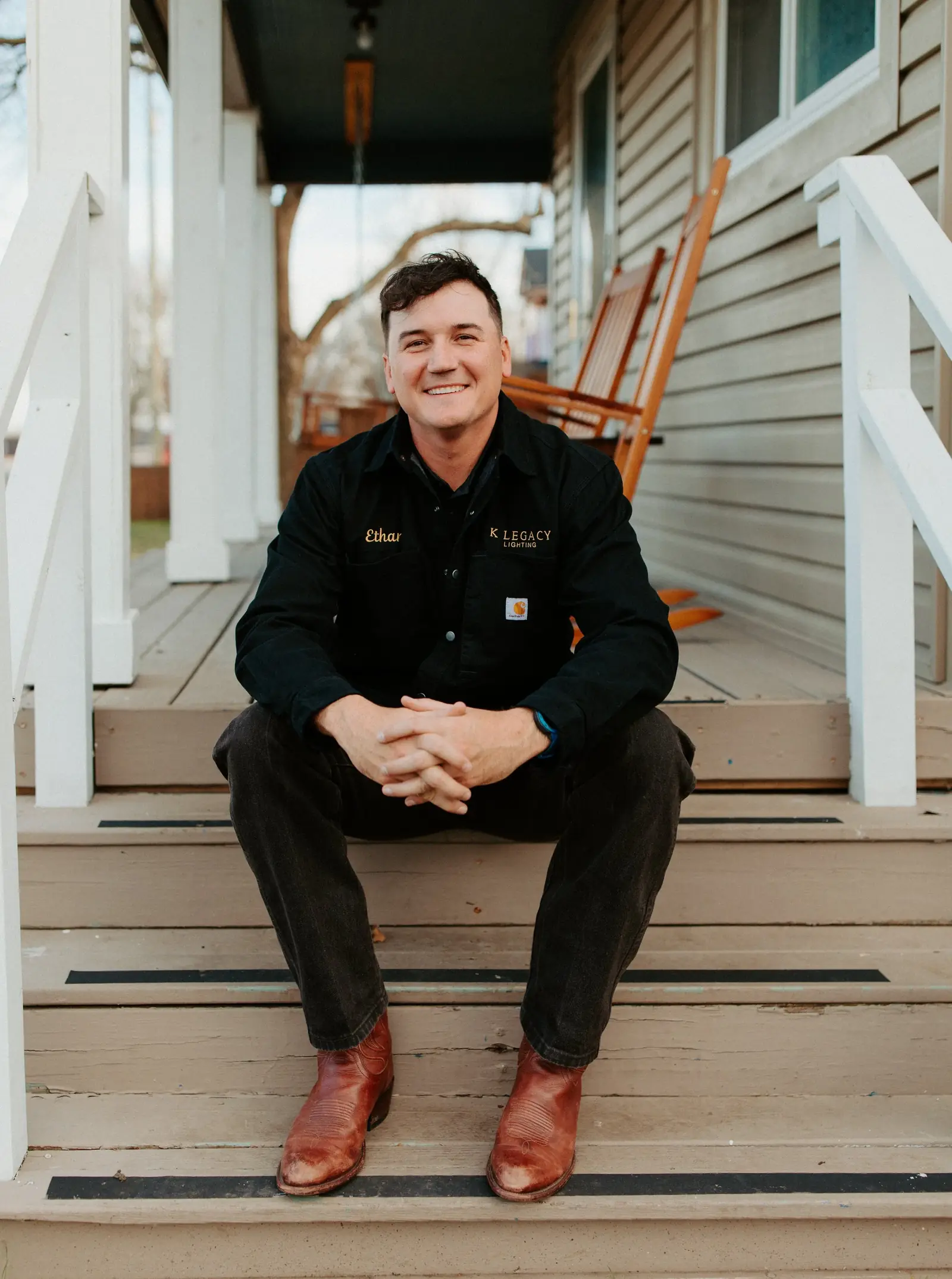 Ethan Knowles, founder of K Legacy Lighting, on a front porch in Van Alstyne, Texas
